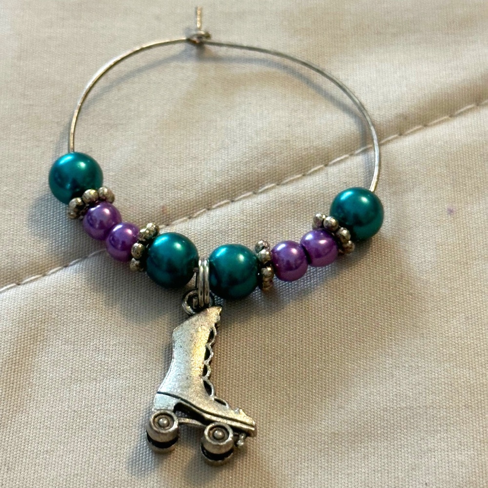 Wine glass tag. Stainless steel hoop. Purple/Turquoise beads roller skate